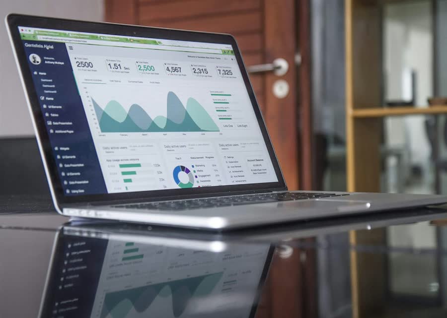 Laptop displaying an analytics dashboard on a business desk